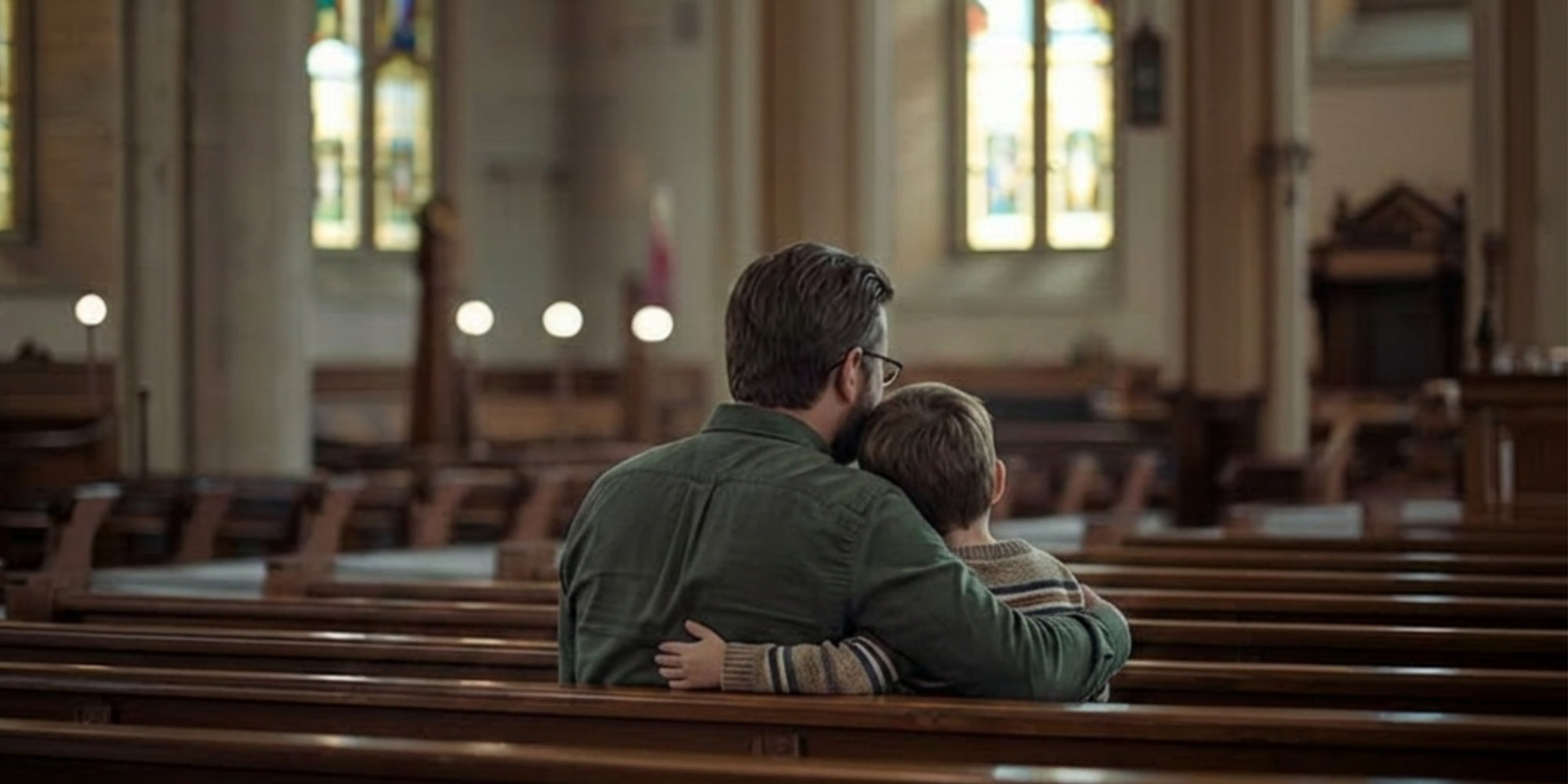 Father hugging son in pew of Catholic Church